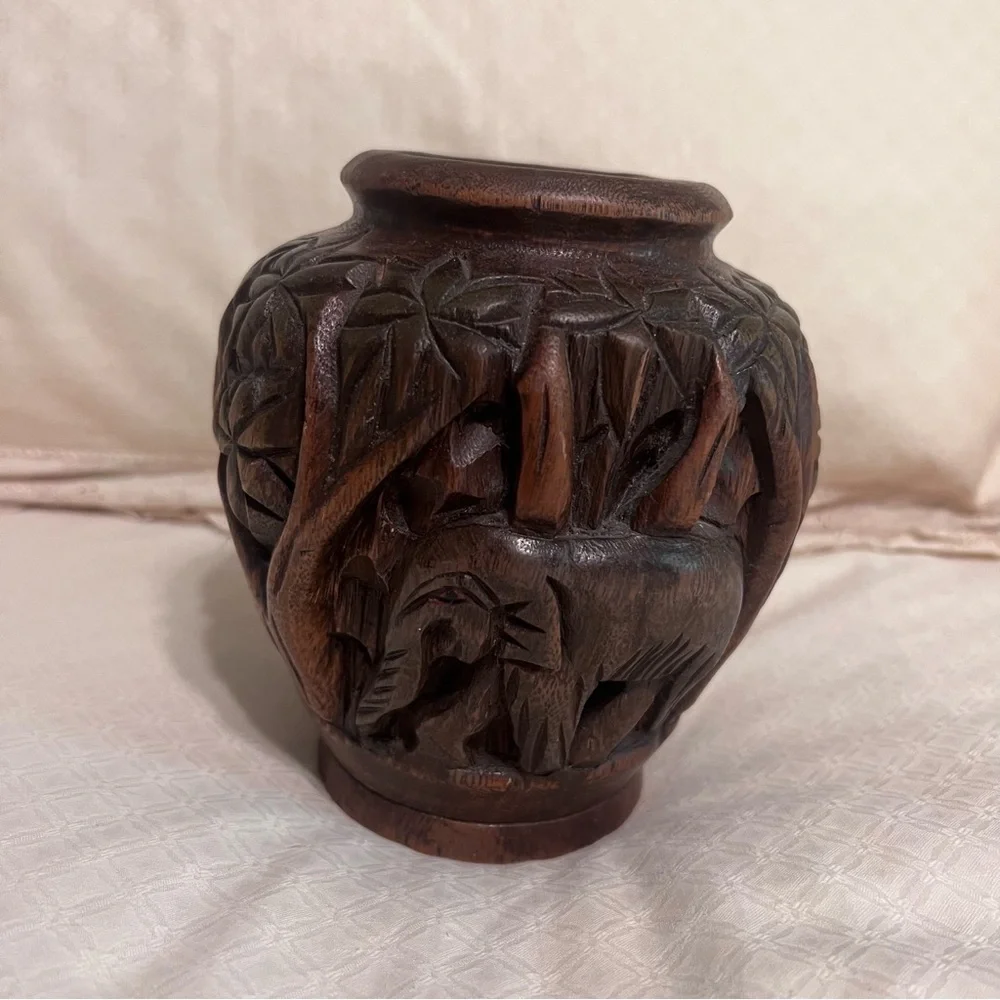 Carved wooden type vase with elephant. Approximately 6 inches high.